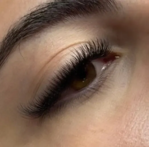 A soft, flicked lash set on a brown eye, with a clean lash line
